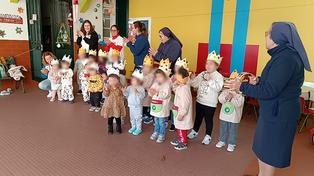 Preschool children wearing crowns and participating in a school activity.