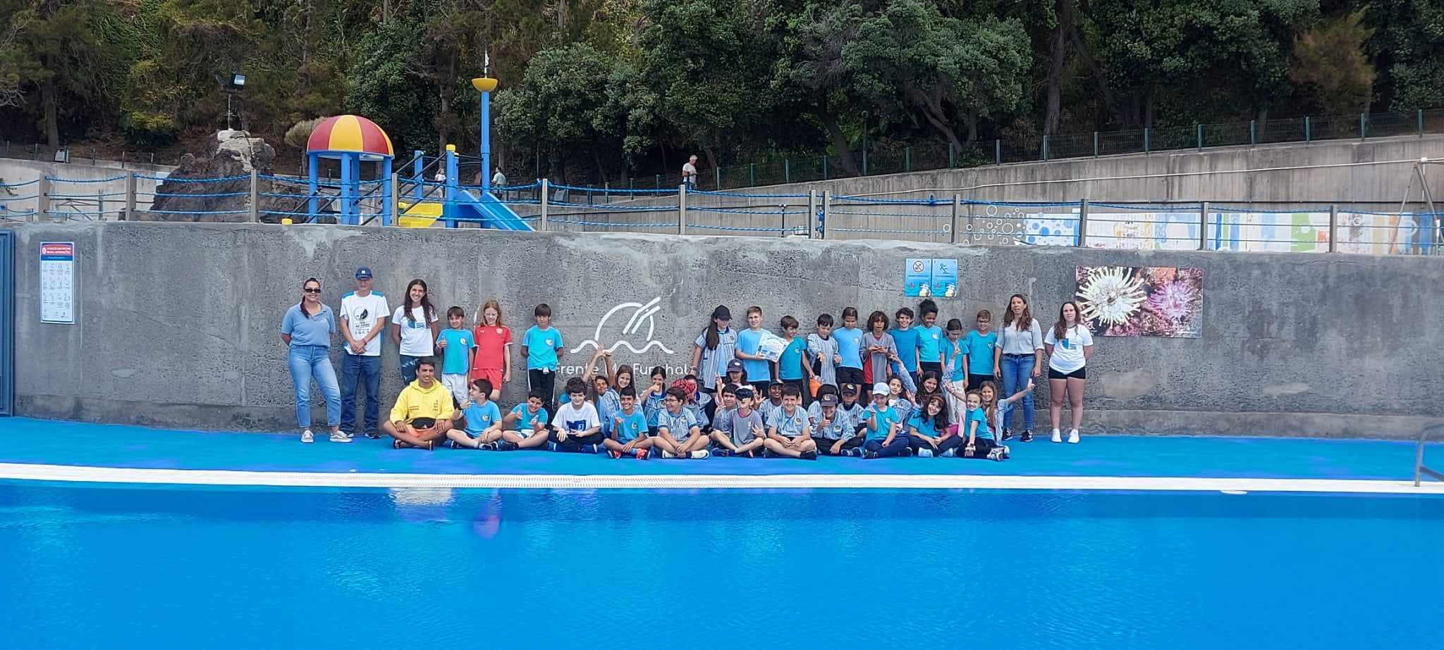 Ajuda Basic School students and teachers at an outdoor pool