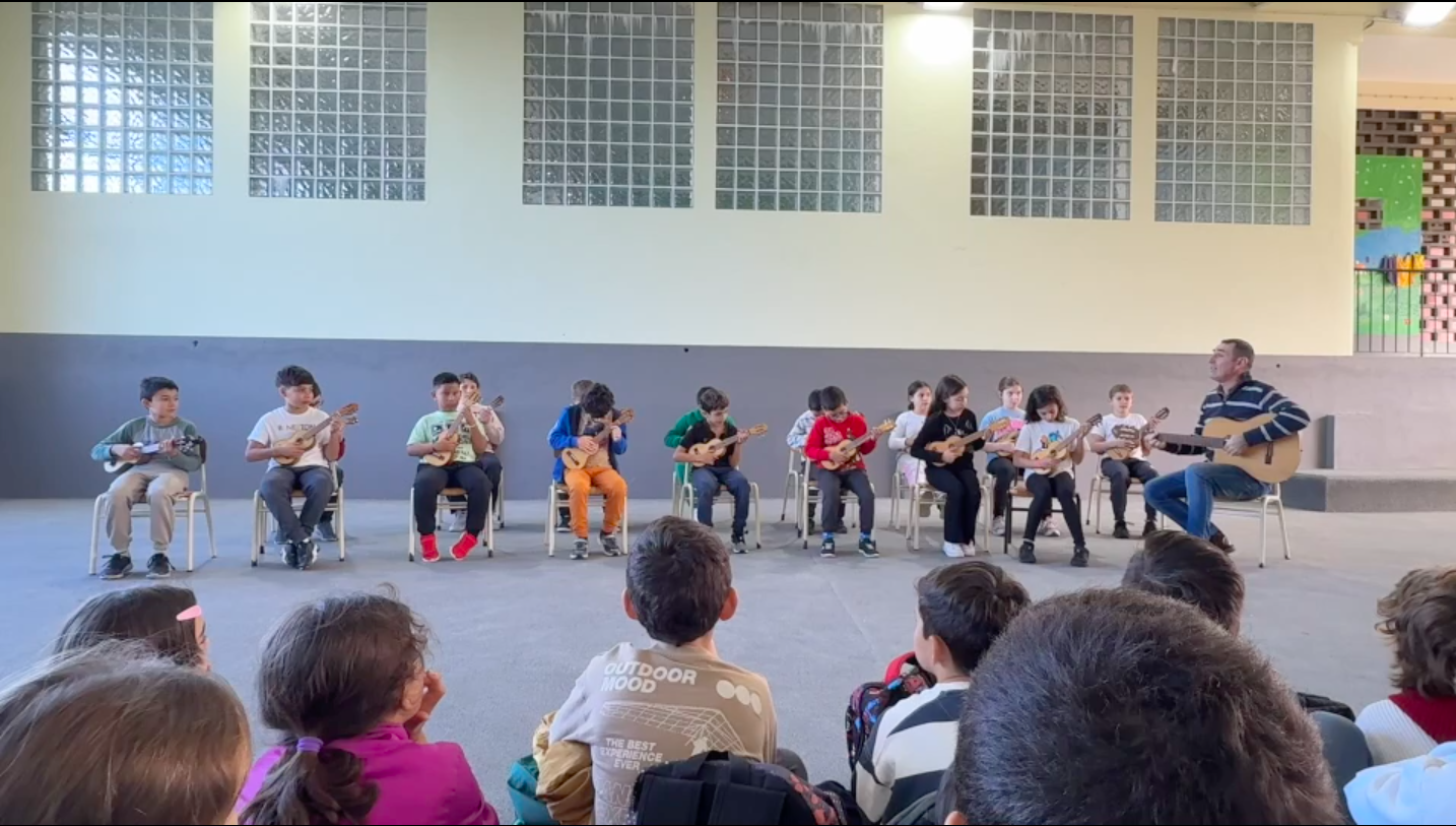 Preschool children playing ukuleles in a music class