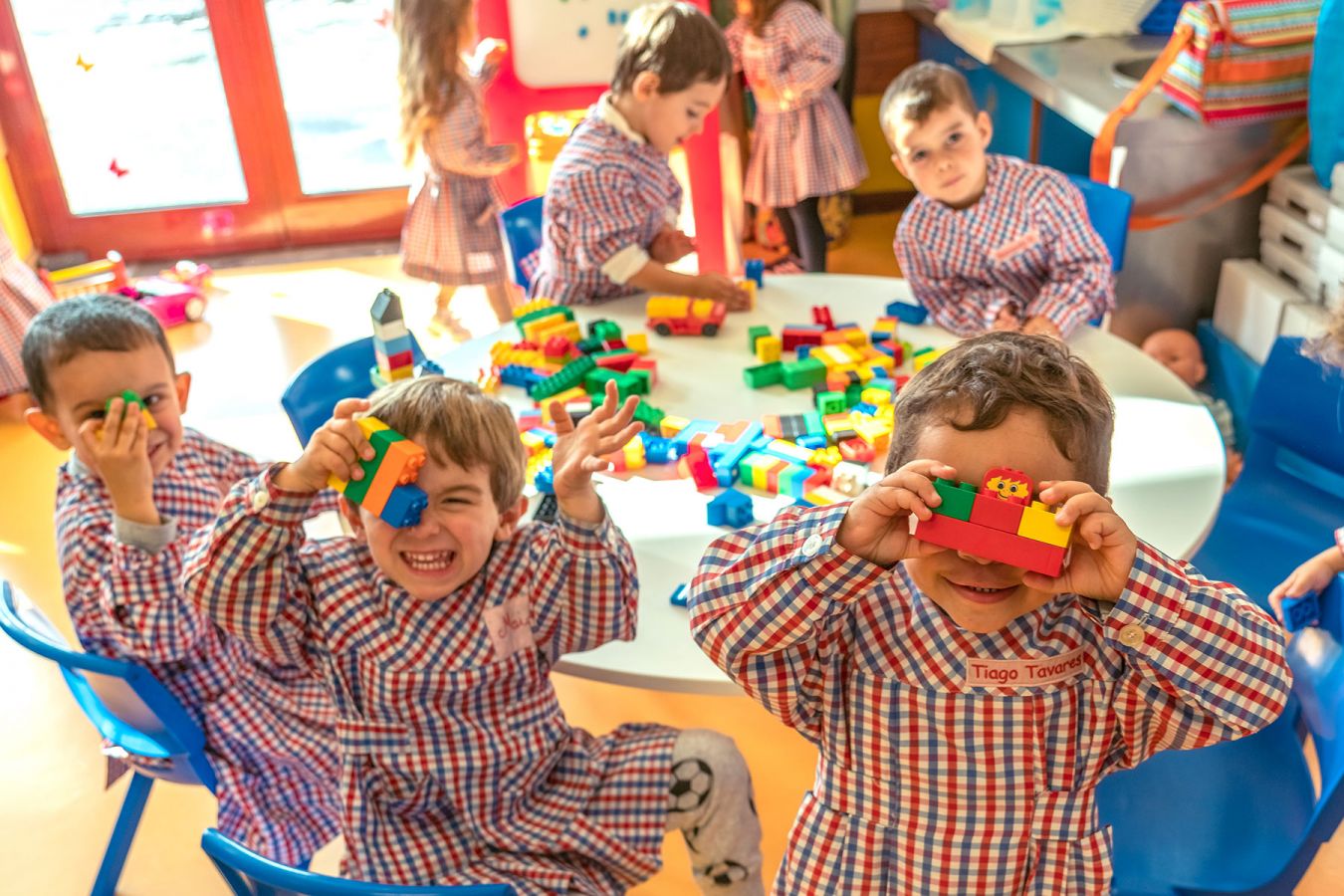 Preschool children playing with colorful blocks during class