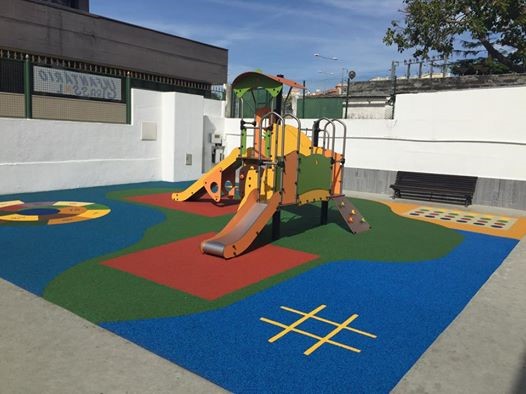 Infantário Girassol playground with colorful play structures and safety surfacing