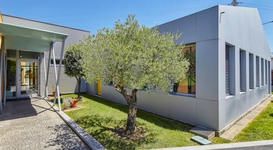 Exterior view of Creche Jardim De Infáncia Atl preschool, showing building and landscaping