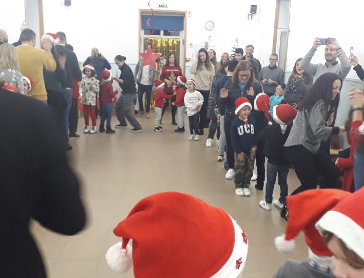 Preschool children in Santa hats participating in a Christmas event