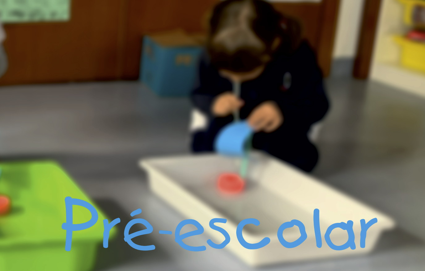Preschool child playing with water and paper boat