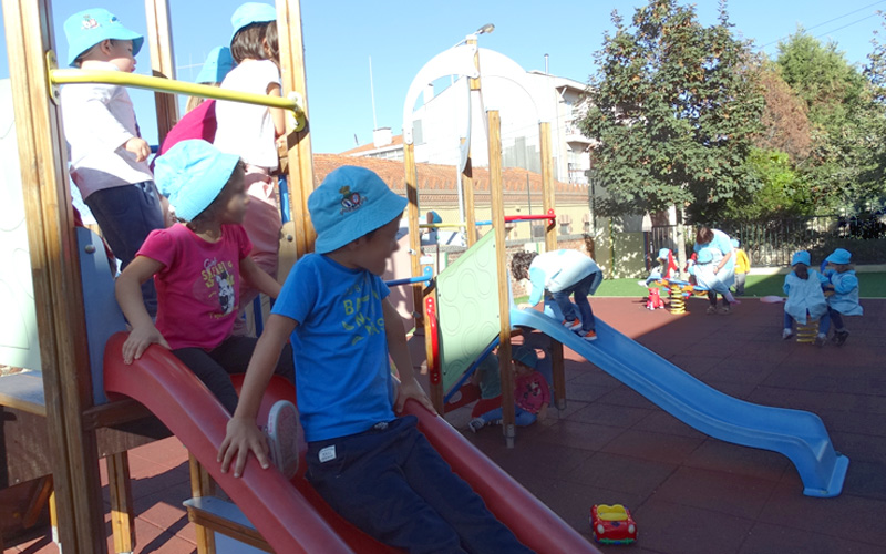 Preschool children playing on playground equipment
