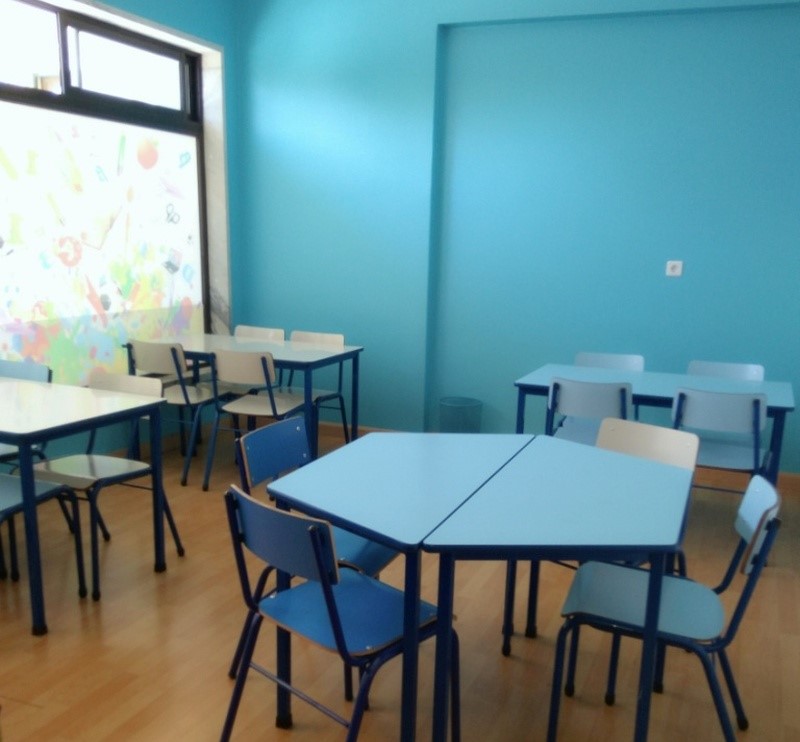 Preschool classroom with light blue tables and chairs