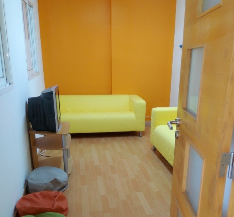 Yellow couches and a TV in a preschool room