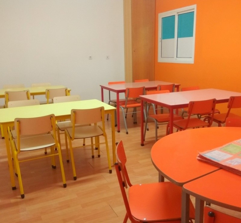 Preschool classroom with colorful tables and chairs