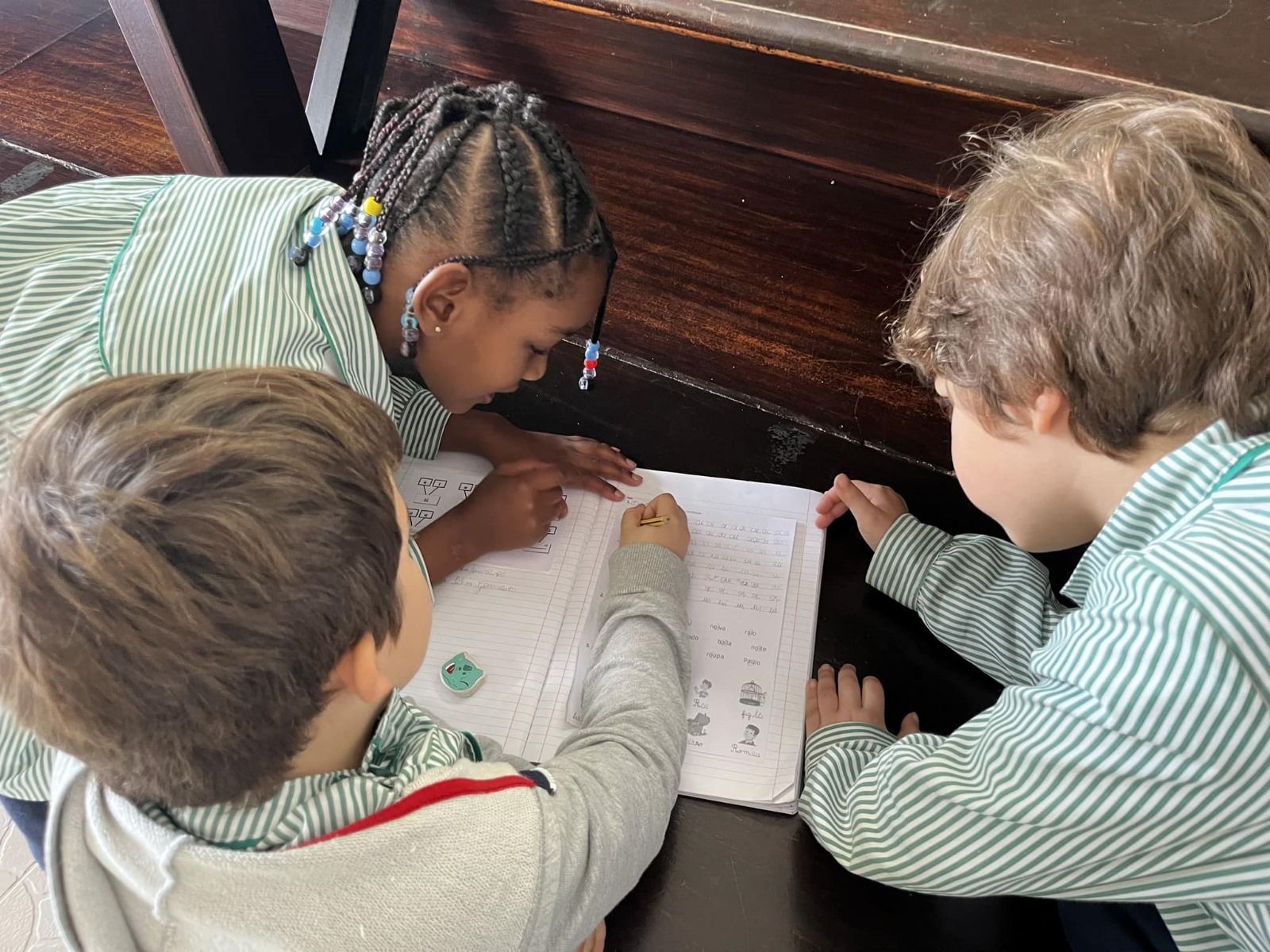 Preschool children collaborating on a classroom activity.