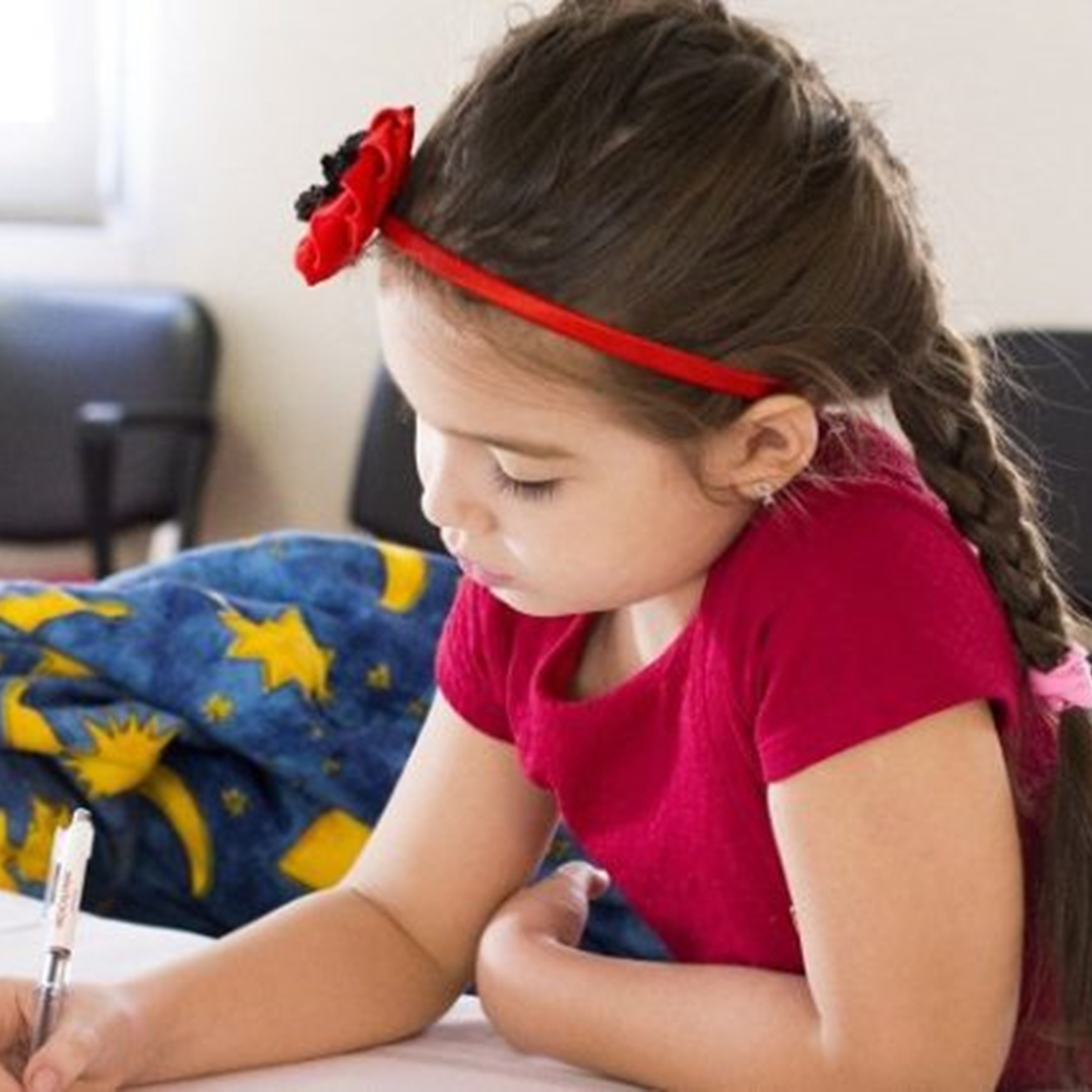 Preschool girl writing