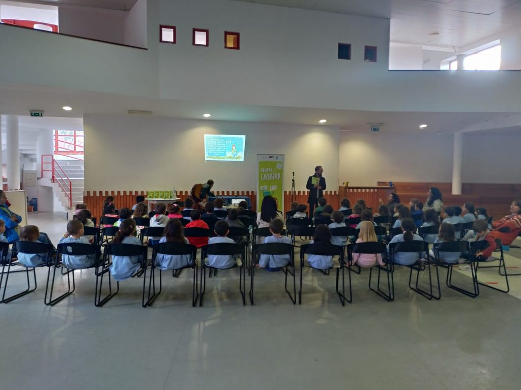 Preschool children attentively listening to a story during a school event.