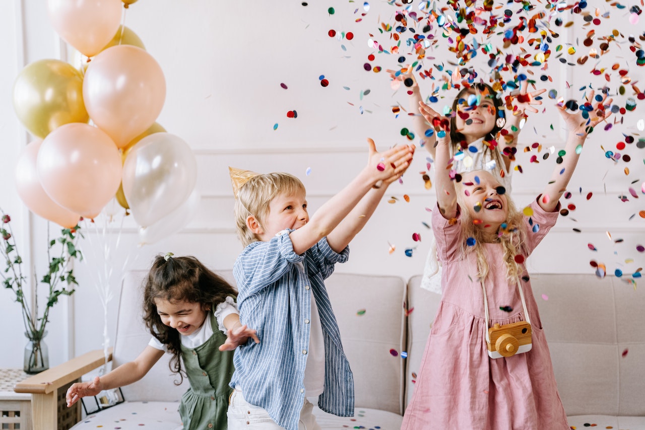 Preschool children playing with confetti