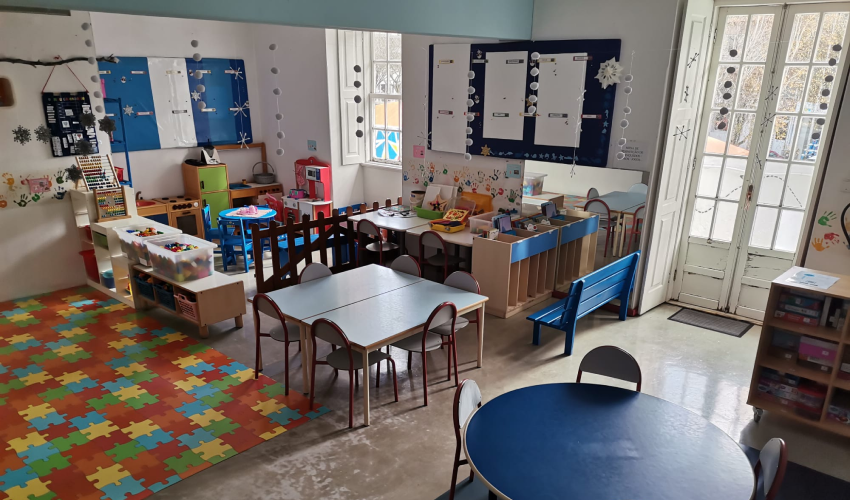 Preschool classroom with colorful furniture and play area