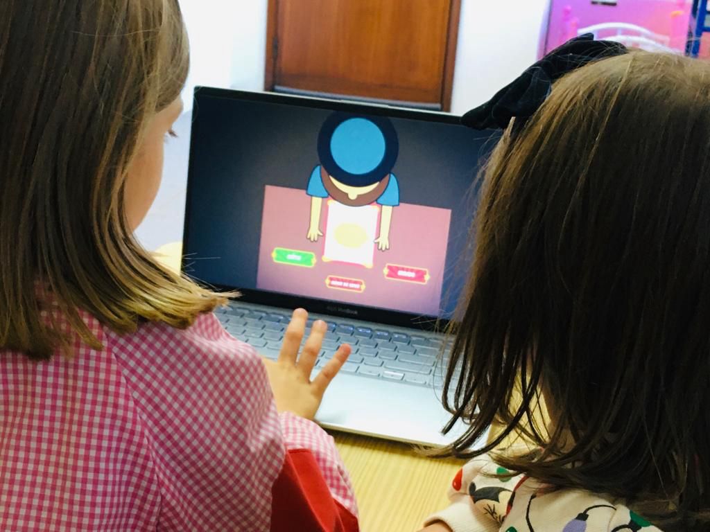 Two preschool children using a laptop for educational purposes