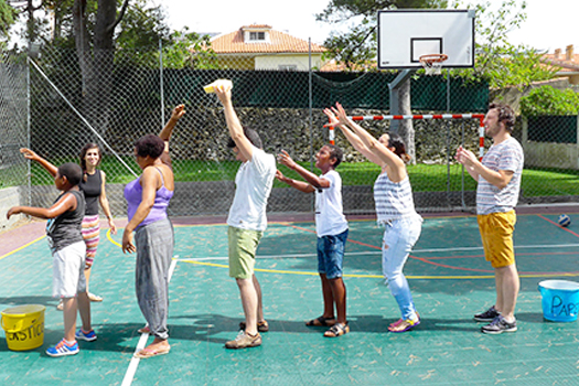 Preschool children and teachers playing a game outdoors