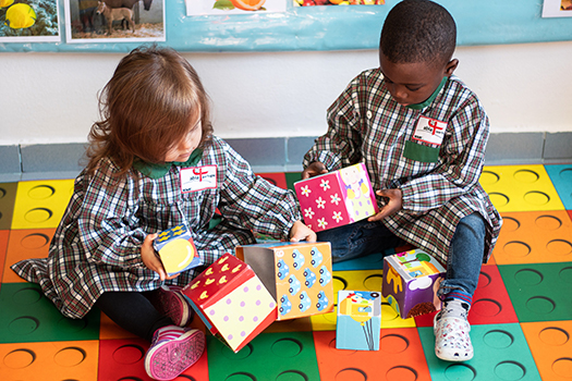 Preschool children playing with colorful blocks