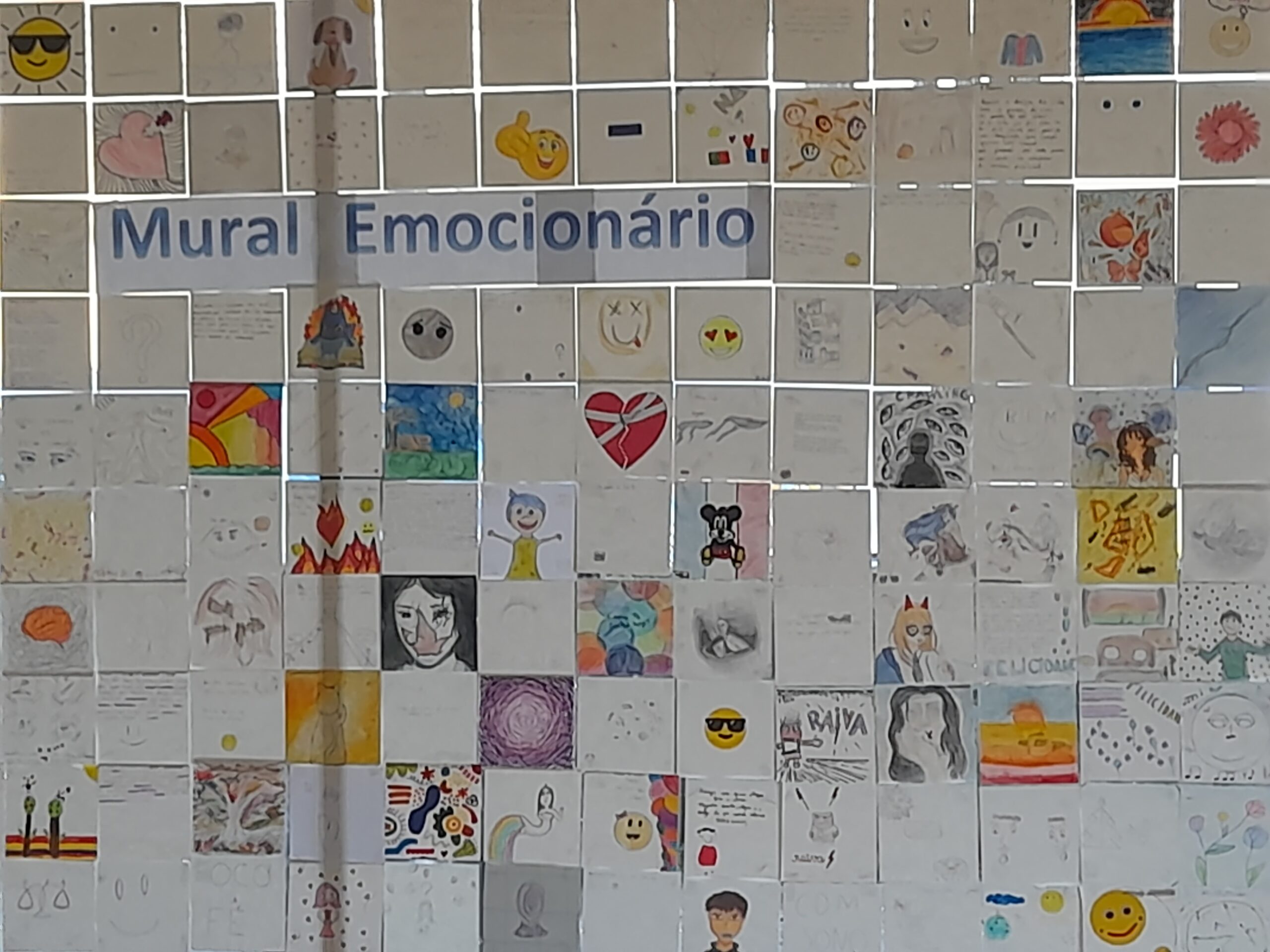 Children's artwork displayed on a wall, showcasing a variety of drawings and emotions.