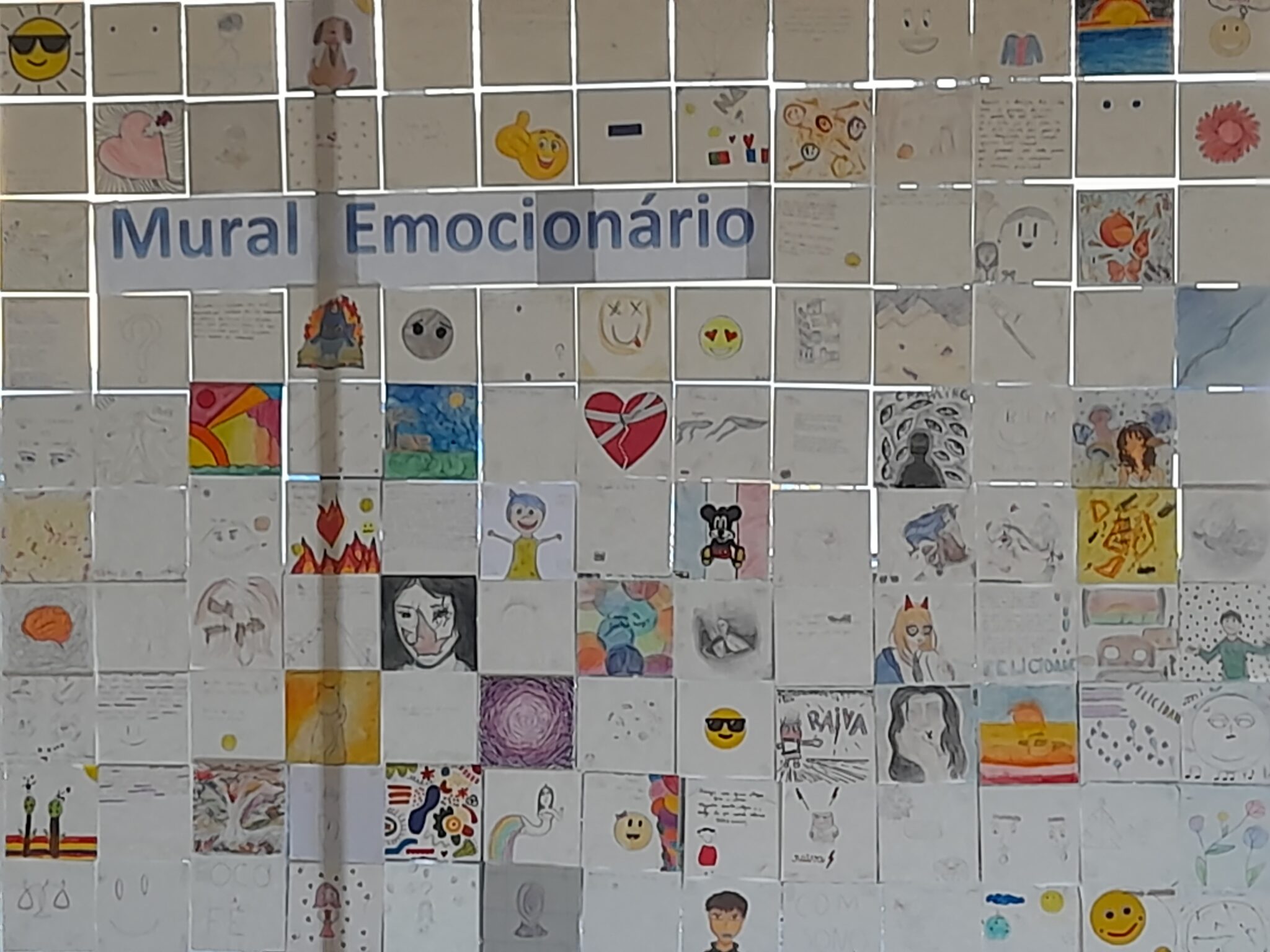 Emotional Mural: A colorful display of children's artwork showcasing various emotions.