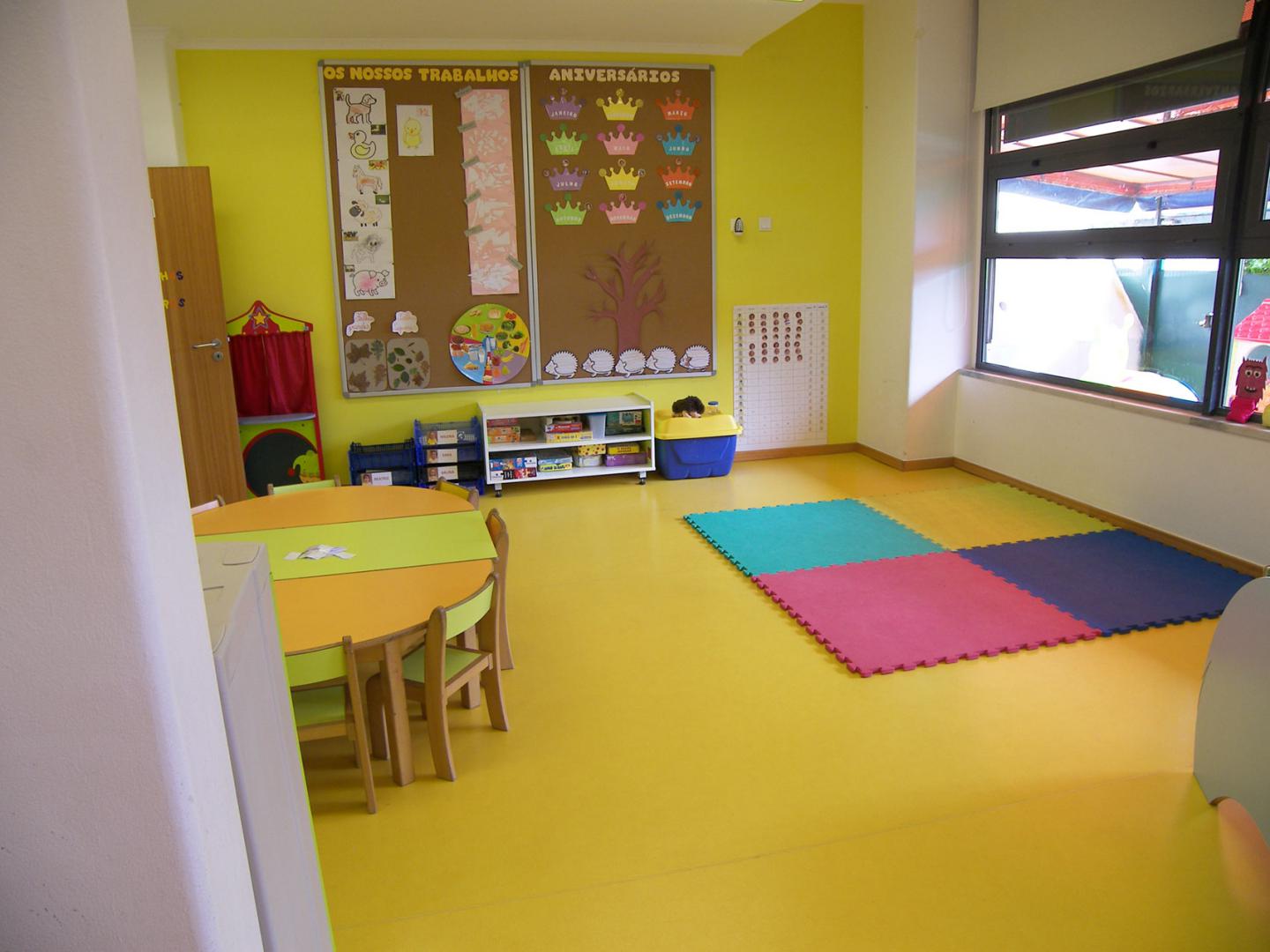 Preschool classroom with colorful furniture and educational materials