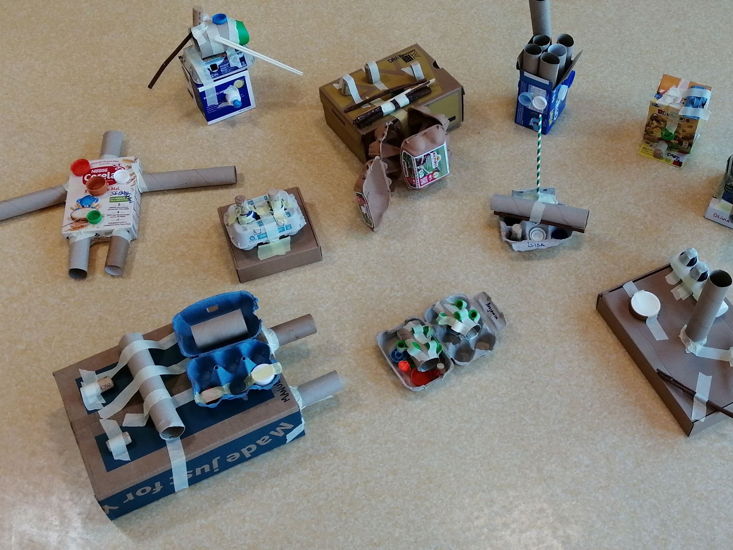 Preschoolers' creations made from recycled materials during a crafting activity.
