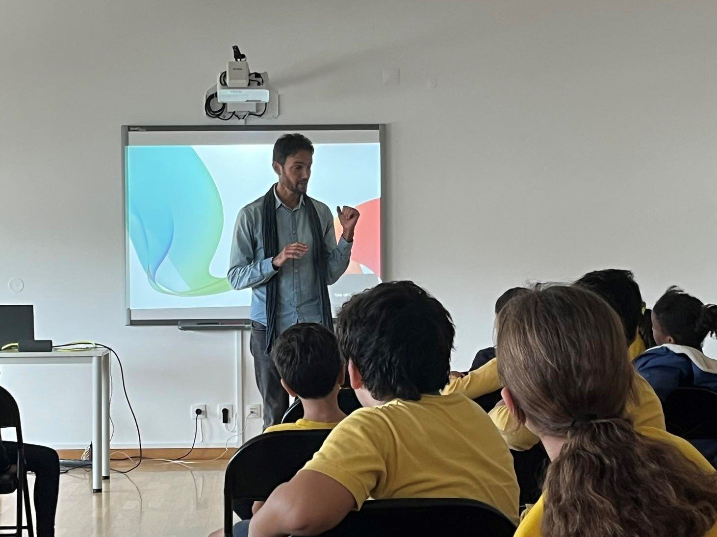 Students attentively listening to a teacher during a presentation