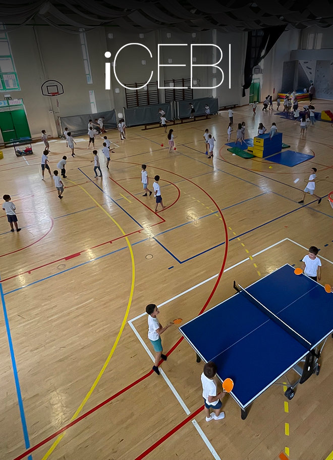 Preschool children playing table tennis and other games in a gymnasium