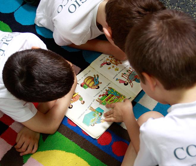 Preschool children attentively reading a book together